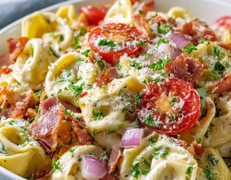Fresh and colorful tortellini salad with vegetables and dressing