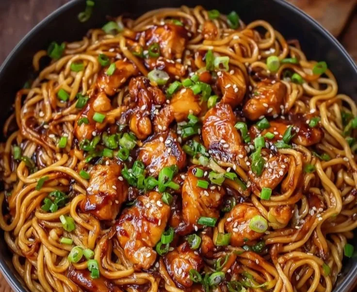 Delicious garlic-glazed chicken served over a bed of noodles
