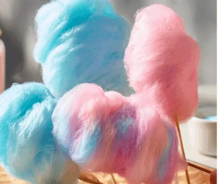 Homemade cotton candy in colorful flavors spun on a cotton candy machine.