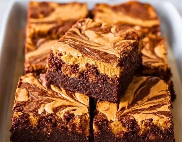 Delicious Peanut Butter Swirl Brownies topped with creamy peanut butter swirls.