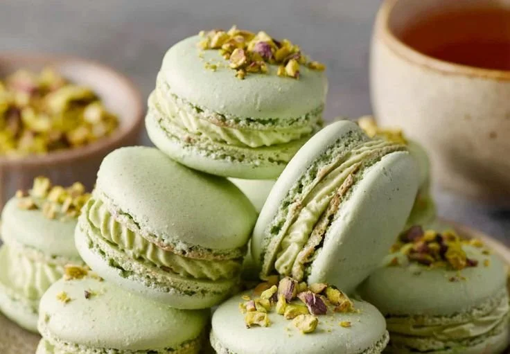 Delicious homemade pistachio macarons displayed on a decorative plate