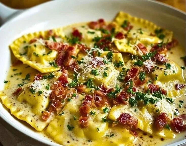 Plate of homemade Ravioli Carbonara topped with cheese and pepper
