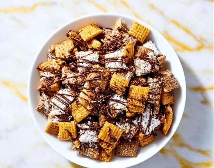 Samoas Puppy Chow recipe with chocolate, peanut butter, and toasted coconut.