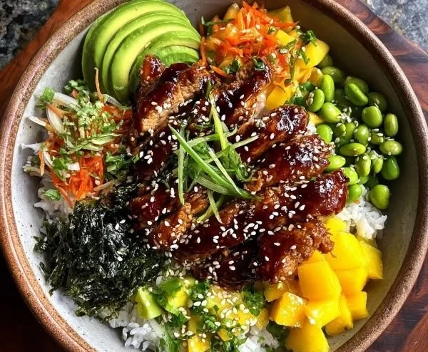 Delicious sticky chicken poke bowls garnished with fresh vegetables and herbs