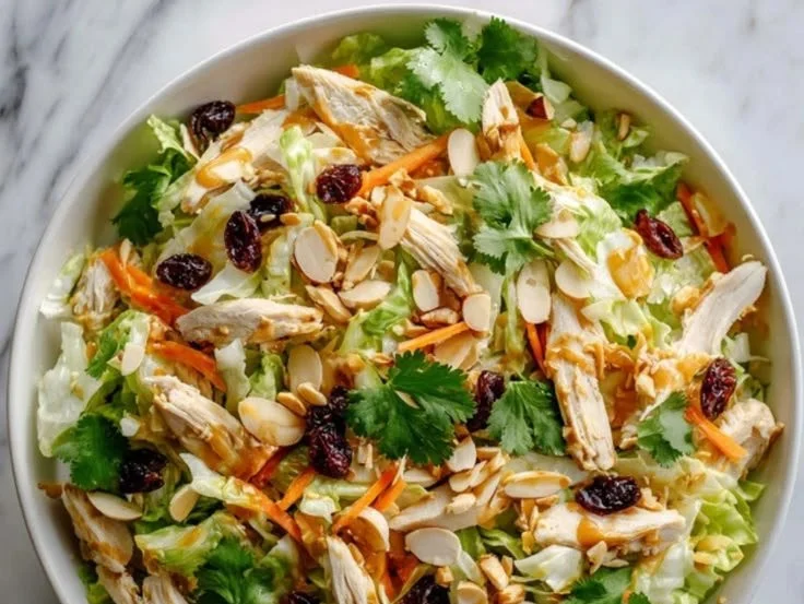 Asian-inspired chicken salad with fresh vegetables and dressings