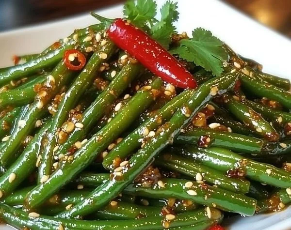 A serving of green beans at a Chinese buffet, showcasing vibrant colors and freshness.