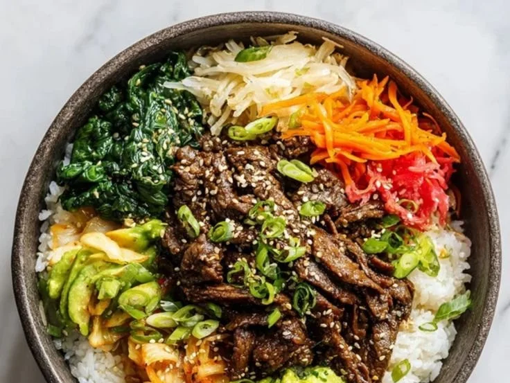 Korean Bulgogi Beef Rice Bowl garnished with vegetables and served in a bowl