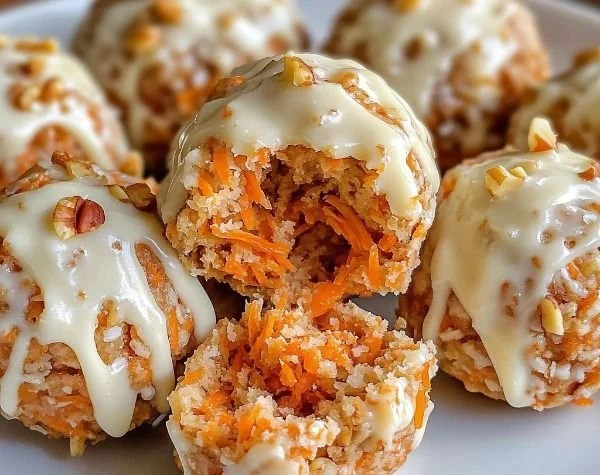 No-bake carrot cake bites with cream topping on a white plate