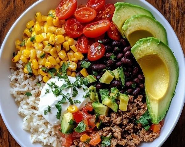 Bowl of Pioneer Woman burrito bowl filled with rice, beans, and toppings.